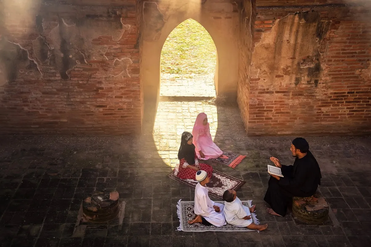 asian-muslim-man-taught-his-son-young-daughter-read-prayers-god-mosque-with-sunlight-shining-through-windows-doors-learn-quran-academy-online-teacher-tutor-classes